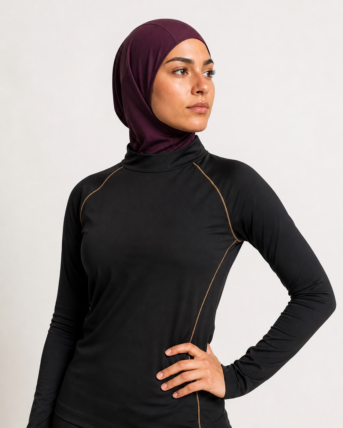 Athlete wearing a deep royal purple sports hijab and black performance top