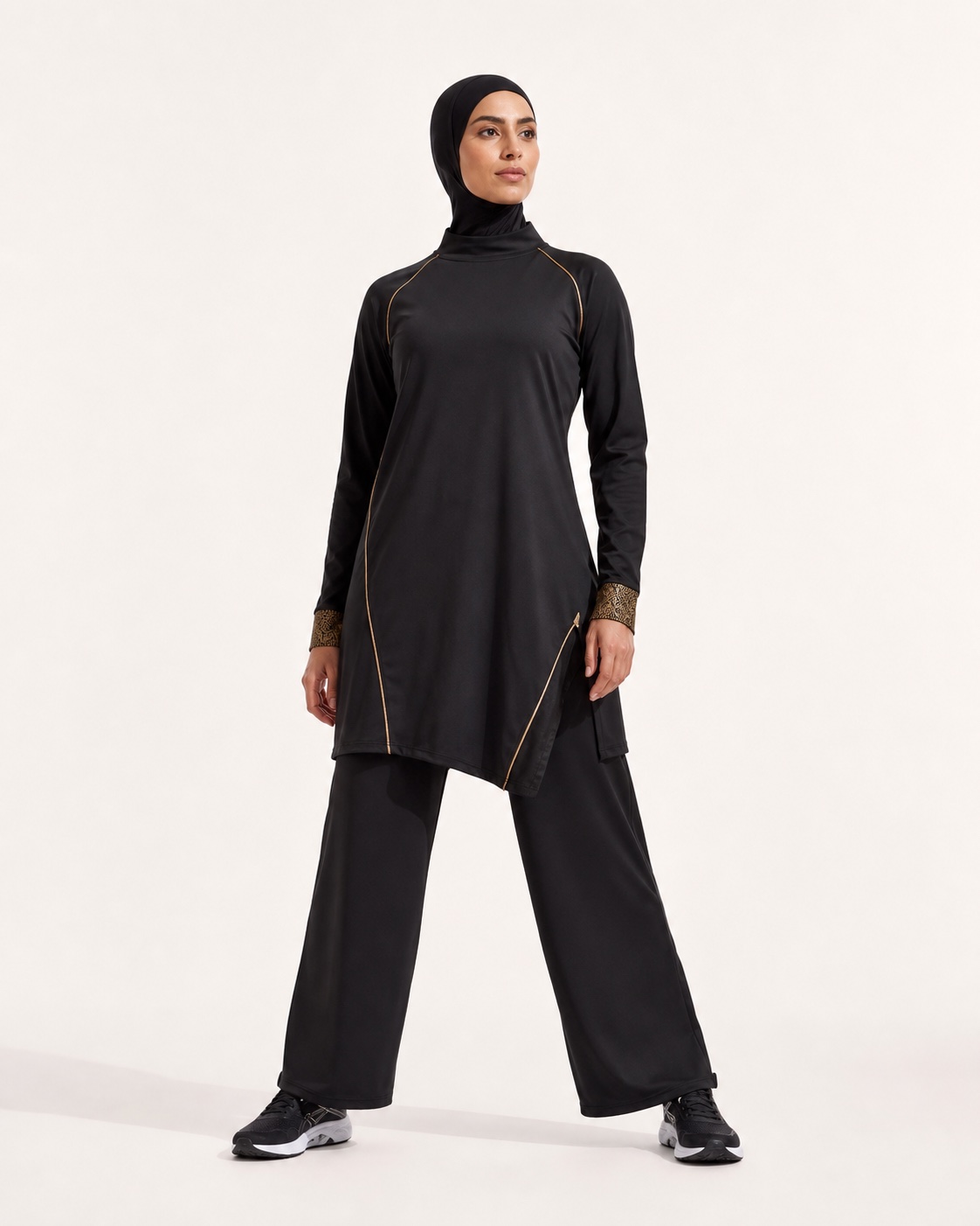 Athlete wearing a black high-neck tunic and wide-leg performance pants
